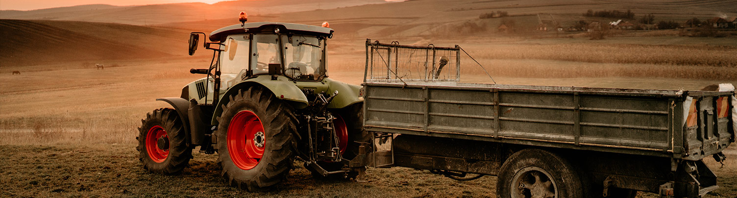 Tractor pulling fertilizer cart in field